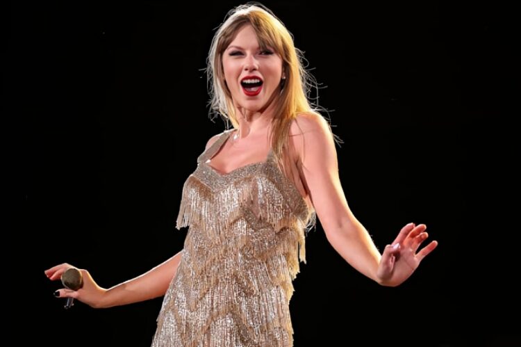 A glittering golden stage costume shimmering under bright spotlights, surrounded by stage lights.