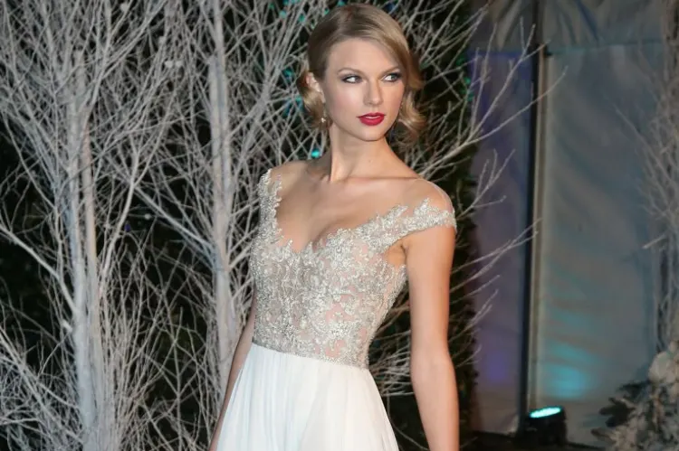 Taylor Swift wearing a flowing princess-style ball gown on stage