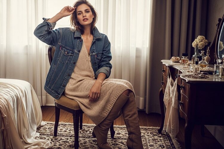 Stylish layered look with a denim jacket over a cozy knitted dress.