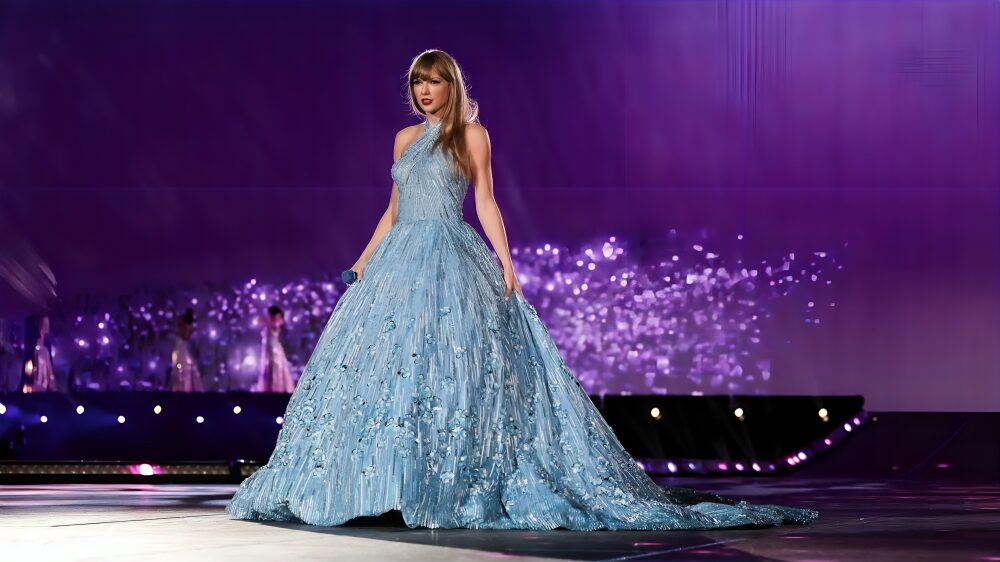 Taylor Swift in a sheer gown embellished with glowing silver stars.