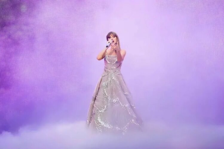Taylor Swift in a shimmering lavender sparkle dress and soft romantic glow.