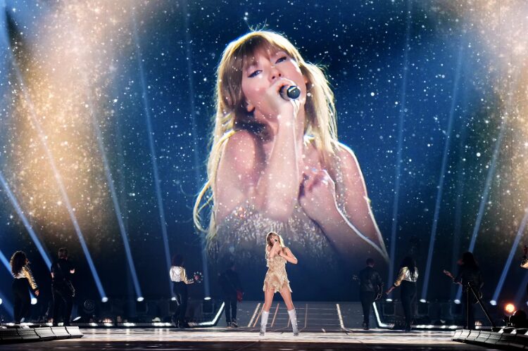 Taylor Swift standing center stage in a dazzling collage of all her Eras Tour outfits.
