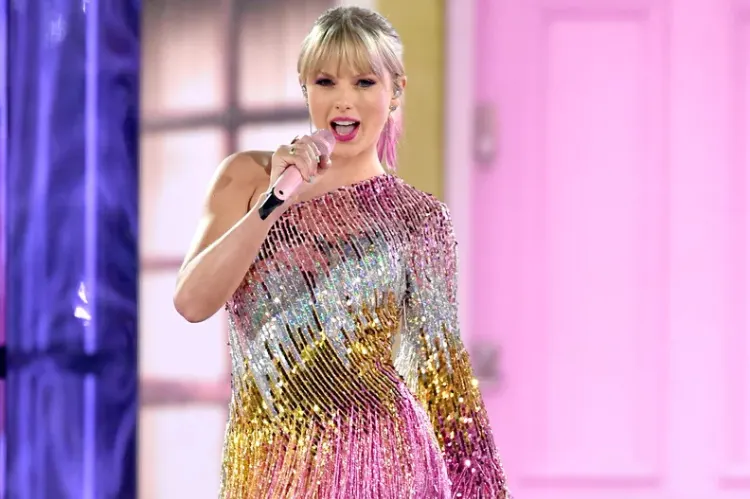 Action shot of Taylor Swift twirling on stage in a glittery fringe dress