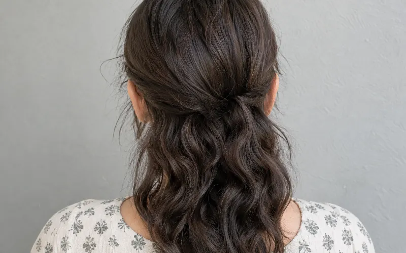Woman with dark brown wavy hair and irish curls, back view.