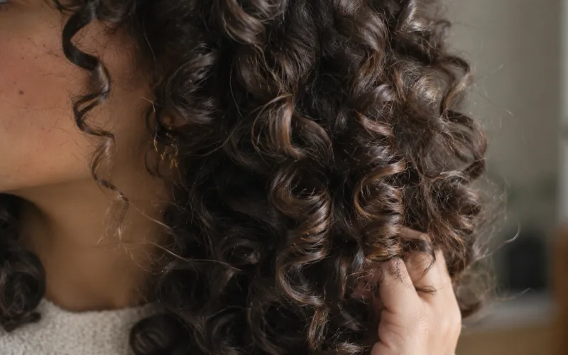 Close-up of defined 3B curly hair strands.
